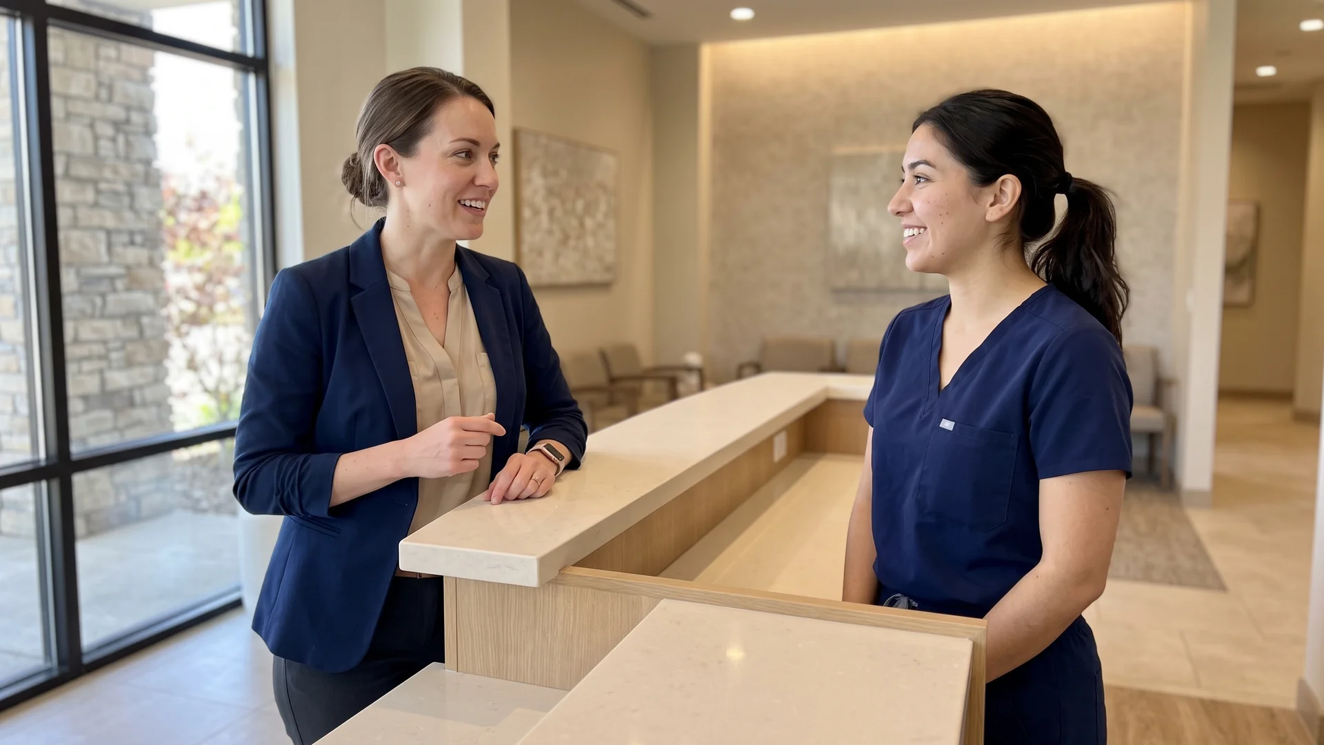 Enhance.work - Blog - hiring for your aesthetic practice - practice manager and clinician reviewing a schedule together at a med spa front desk